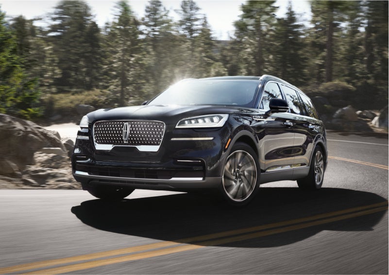A Lincoln Aviator® SUV is being driven on a winding mountain road | Dan Cummins Lincoln in Nicholasville KY