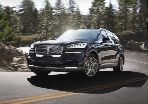 A Lincoln Aviator® SUV is being driven on a winding mountain road | Dan Cummins Lincoln in Nicholasville KY