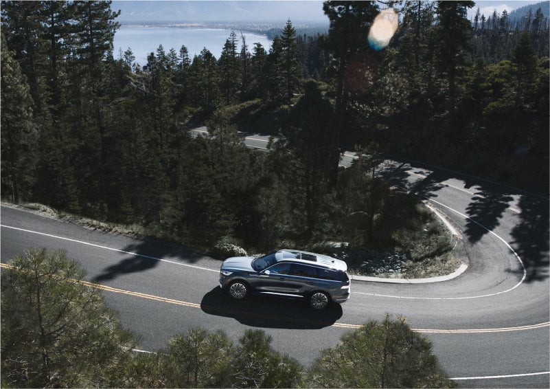 A 2023 Lincoln Aviator® SUV is being driven on a winding mountain road | Dan Cummins Lincoln in Nicholasville KY