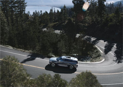 A 2023 Lincoln Aviator® SUV is being driven on a winding mountain road | Dan Cummins Lincoln in Nicholasville KY