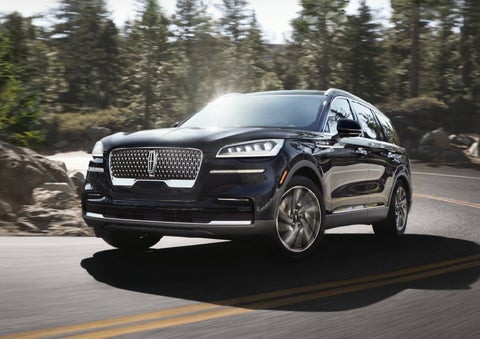 A Lincoln Aviator® SUV is being driven on a winding mountain road | Dan Cummins Lincoln in Nicholasville KY