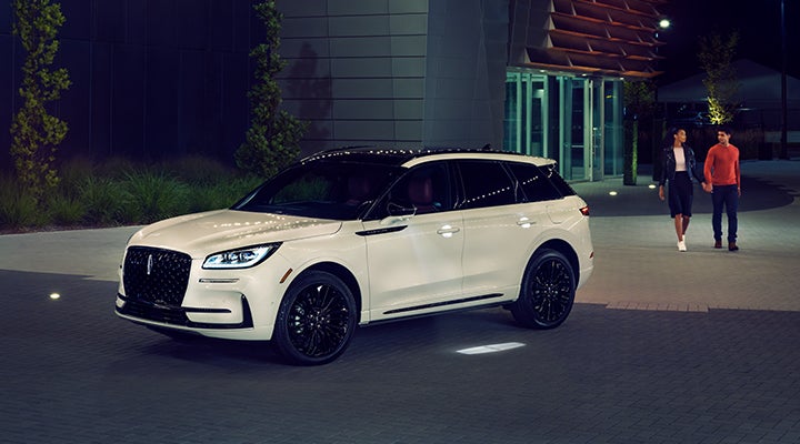 Two people approach a 2024 Lincoln Corsair® SUV featuring the available Jet Appearance Package. | Dan Cummins Lincoln in Nicholasville KY