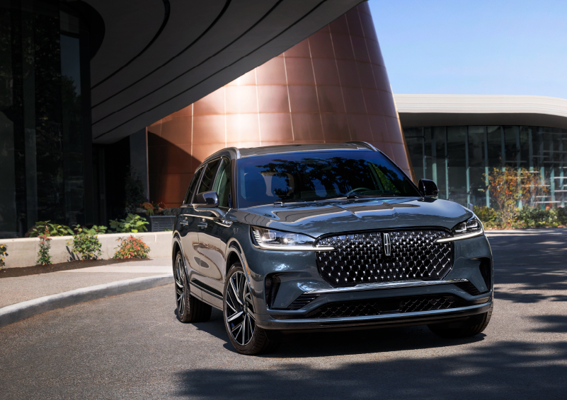 A gray 2025 Lincoln Aviator® SUV is parked outside a modern building with the sun shining. | Dan Cummins Lincoln in Nicholasville KY