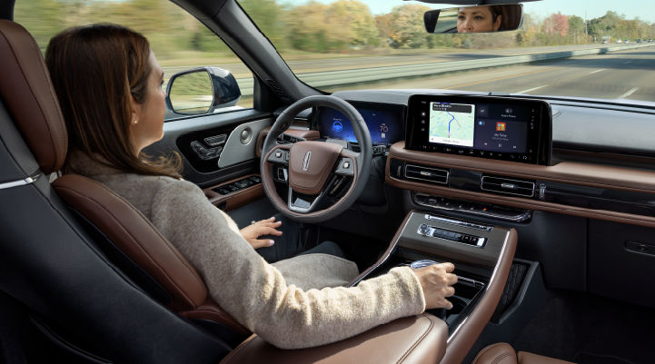 A woman is seen sitting in the driver’s seat of her 2025 Lincoln Aviator® SUV with her hands off the steering wheel. | Dan Cummins Lincoln in Nicholasville KY