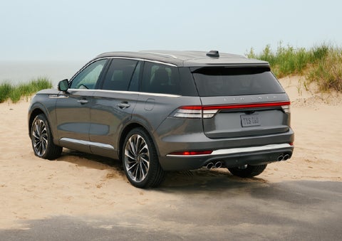 A 2027 Lincoln Aviator® SUV is parked next to sand dunes. | Dan Cummins Lincoln in Nicholasville KY