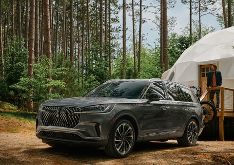 A 2027 Lincoln Aviator® is parked next to a high end glamping site. | Dan Cummins Lincoln in Nicholasville KY