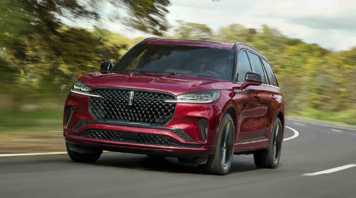A 2027 Lincoln Aviator® SUV is being driven on a country road | Dan Cummins Lincoln in Nicholasville KY