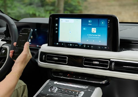 A person pairs thier phone with the center touchscreen of a 2027 Lincoln Aviator® Black Label™ SUV | Dan Cummins Lincoln in Nicholasville KY